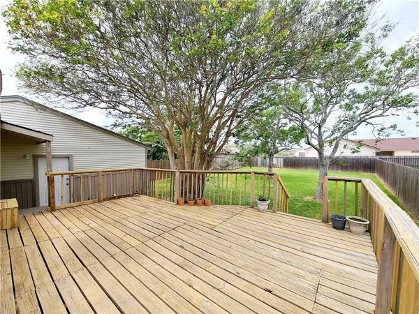 a view of balcony with wooden floor and fence