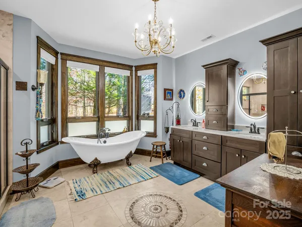 a view of a hallway with wooden floor and a potted plant
