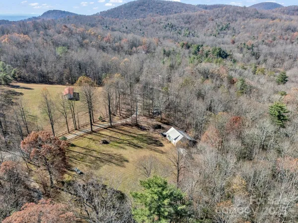 an aerial view of mountain with trees in the background