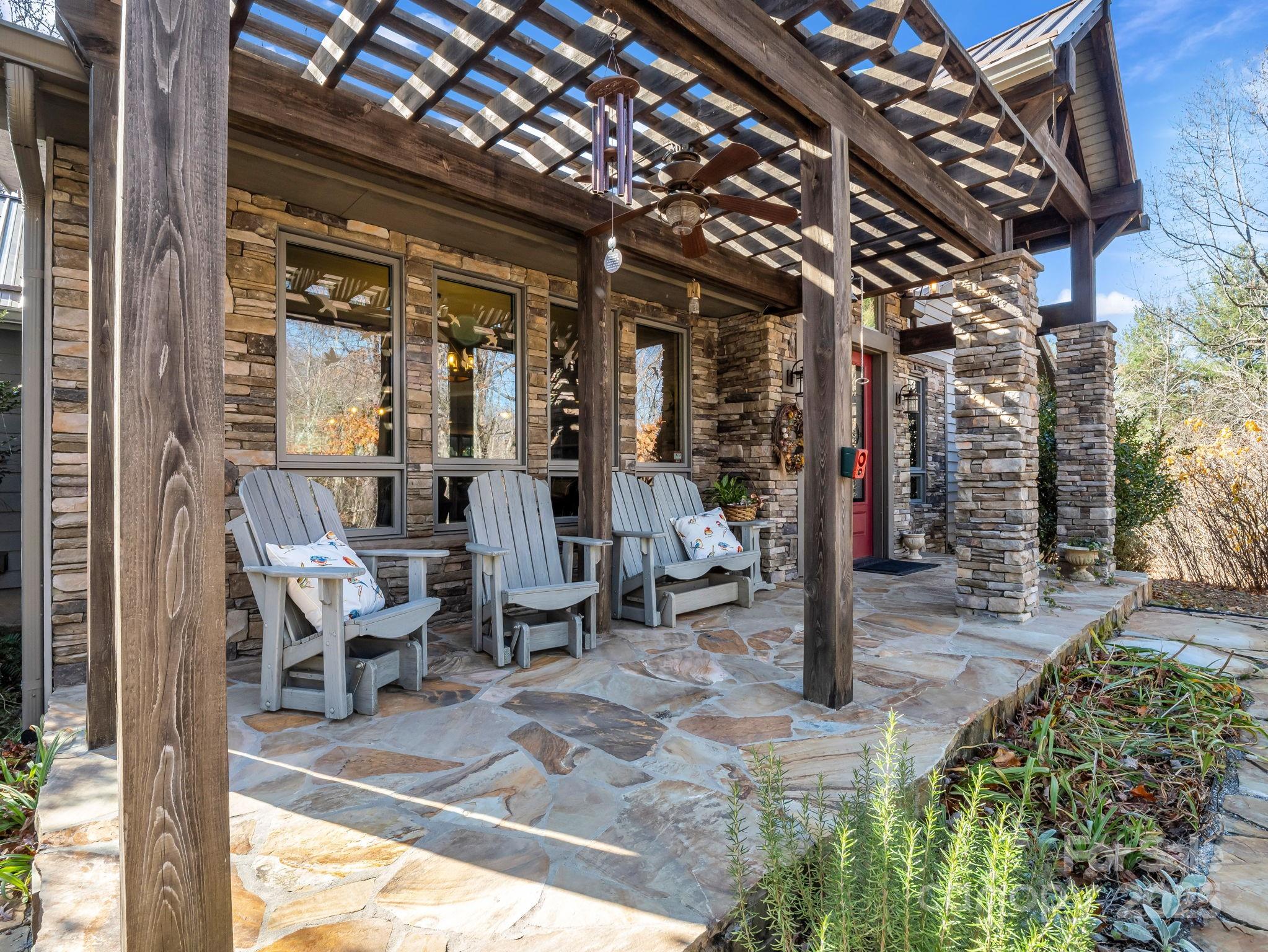 765 Higher Path Drive Saluda, NC 28773 - Photo 4 of 43 a view of a porch with chairs and potted plants