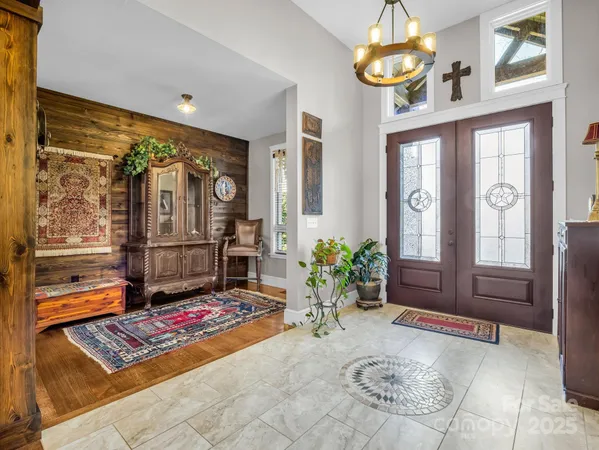 a living room with furniture and a chandelier