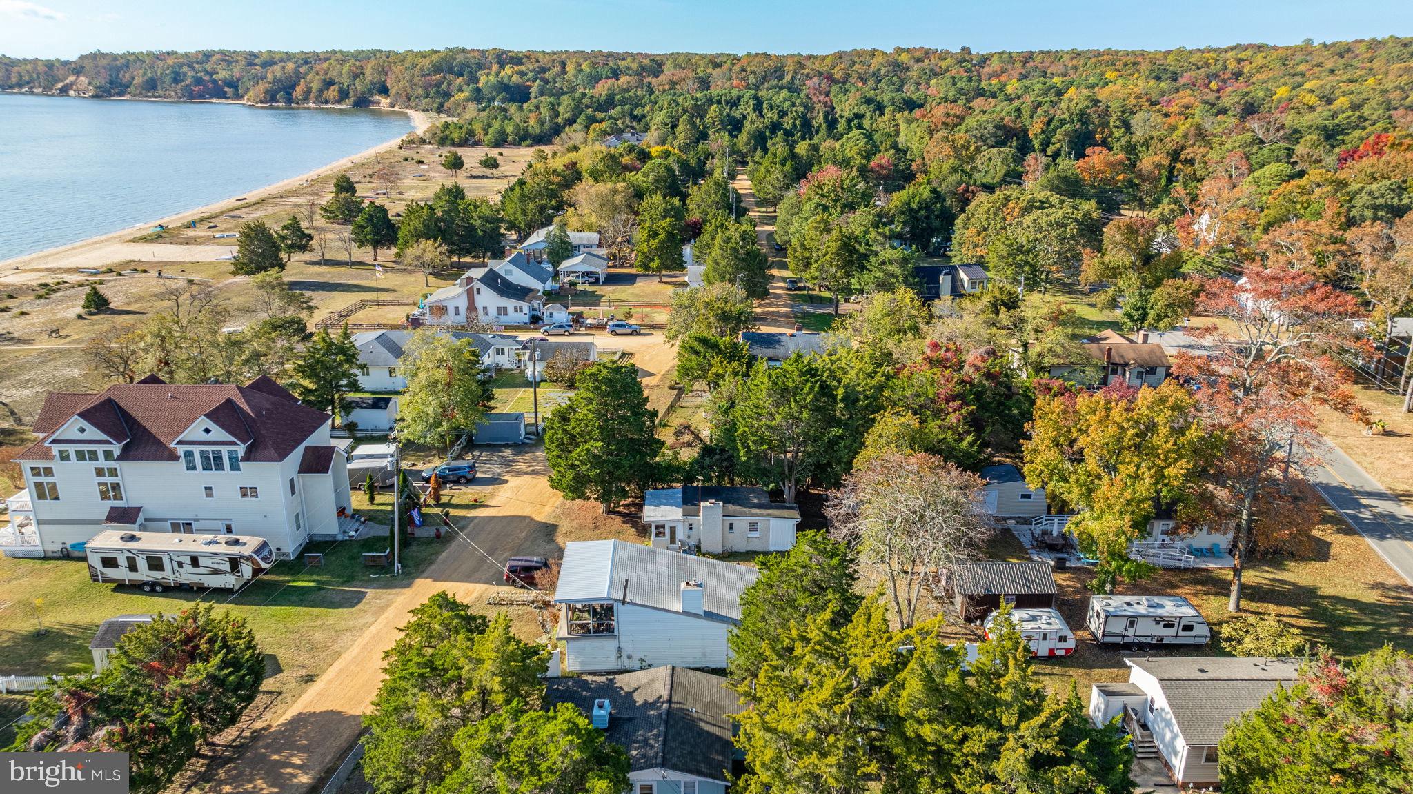 an aerial view of residential houses with outdoor space and lake view