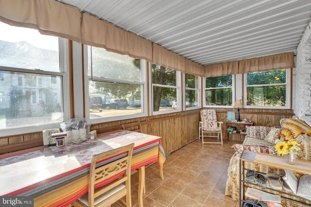 a living room filled with furniture and a large window