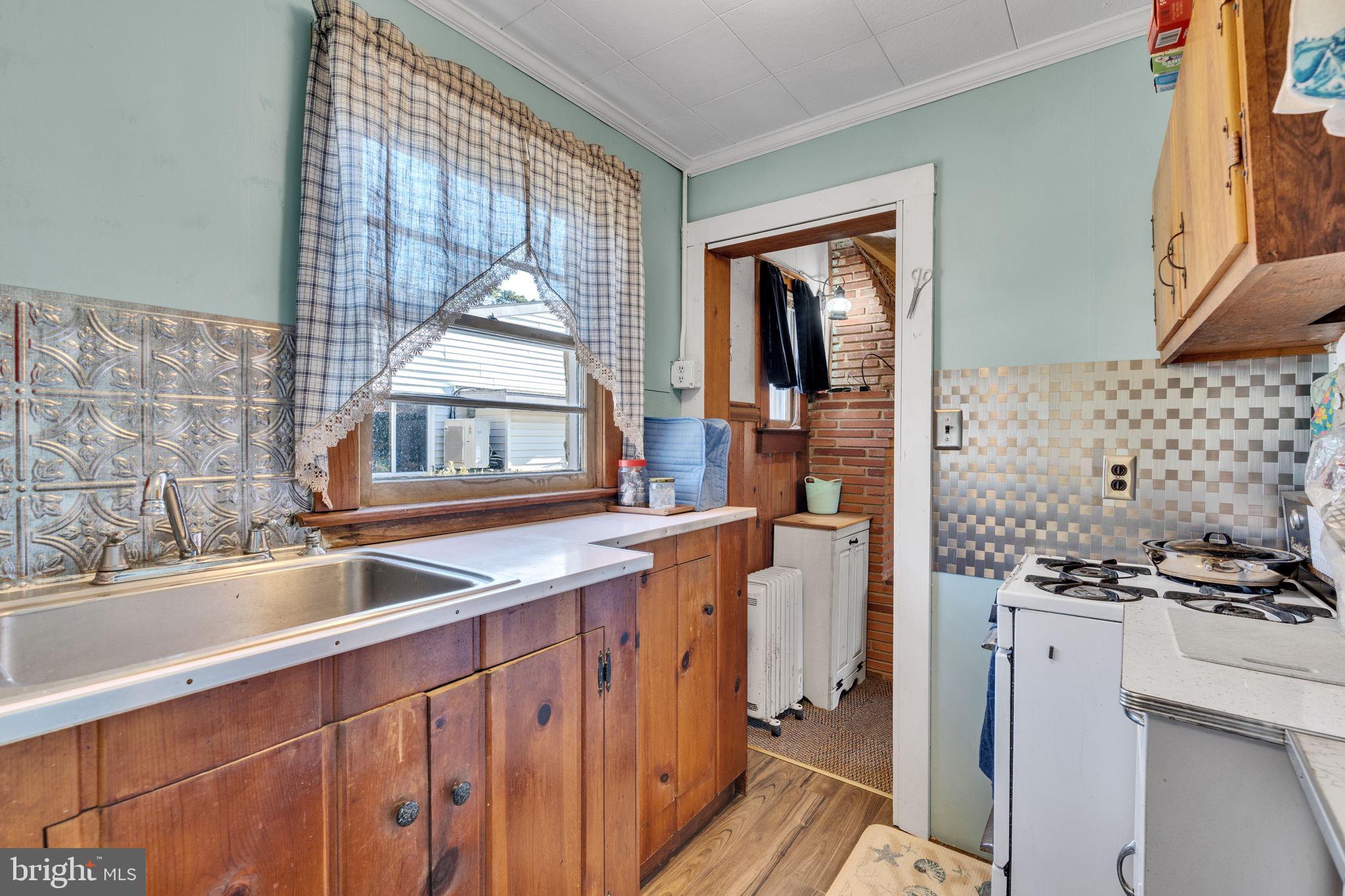 3096 Calvert Boulevard Lusby, MD 20657 - Photo 9 of 21 a kitchen with stainless steel appliances a sink stove and a window