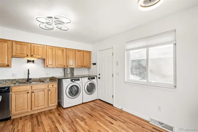 a utility room with sink dryer and washer