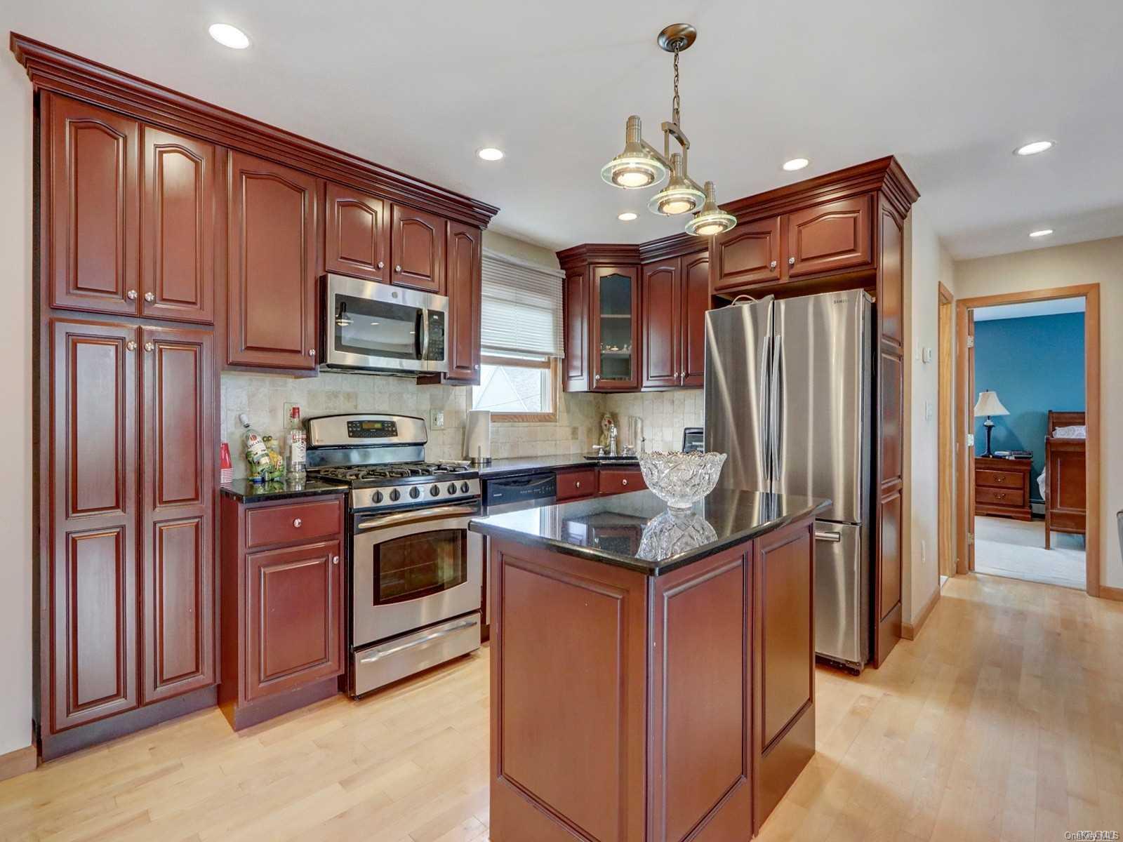 a kitchen with stainless steel appliances granite countertop a refrigerator stove and oven