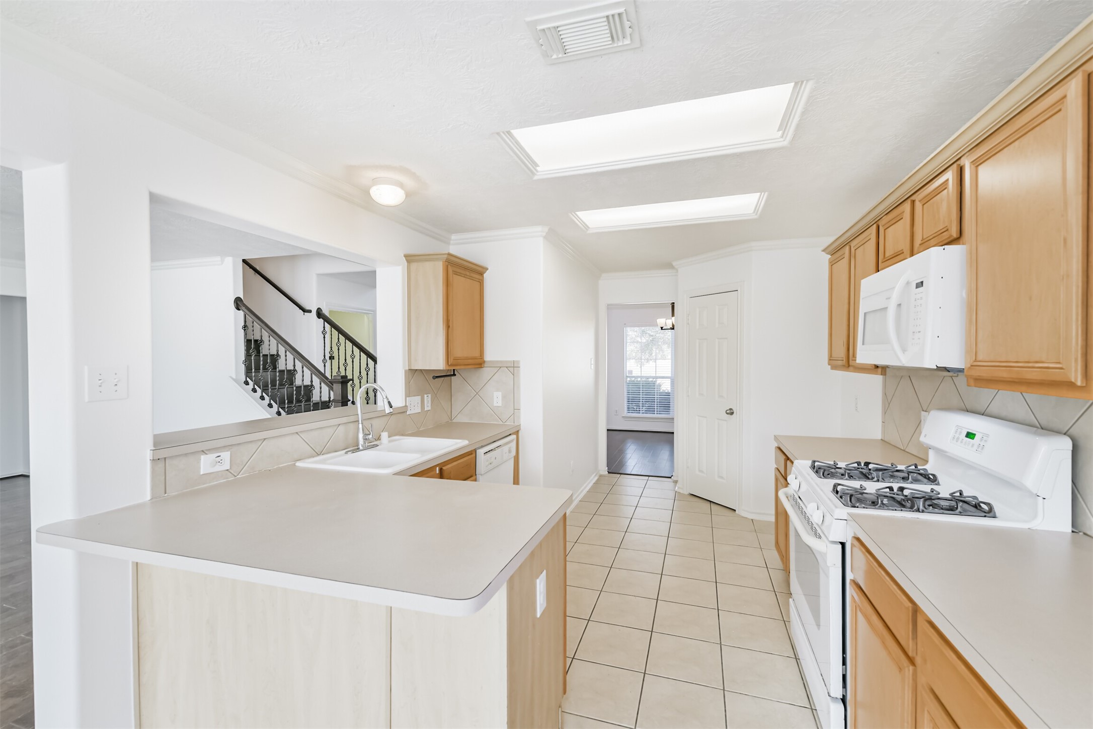 2507 Liza Court Spring, TX 77388 - Photo 11 of 37 a kitchen with a sink a stove and cabinets