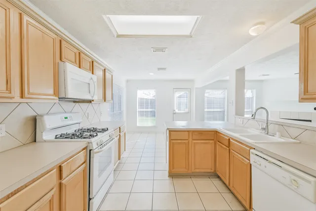 a kitchen with a sink stove and refrigerator