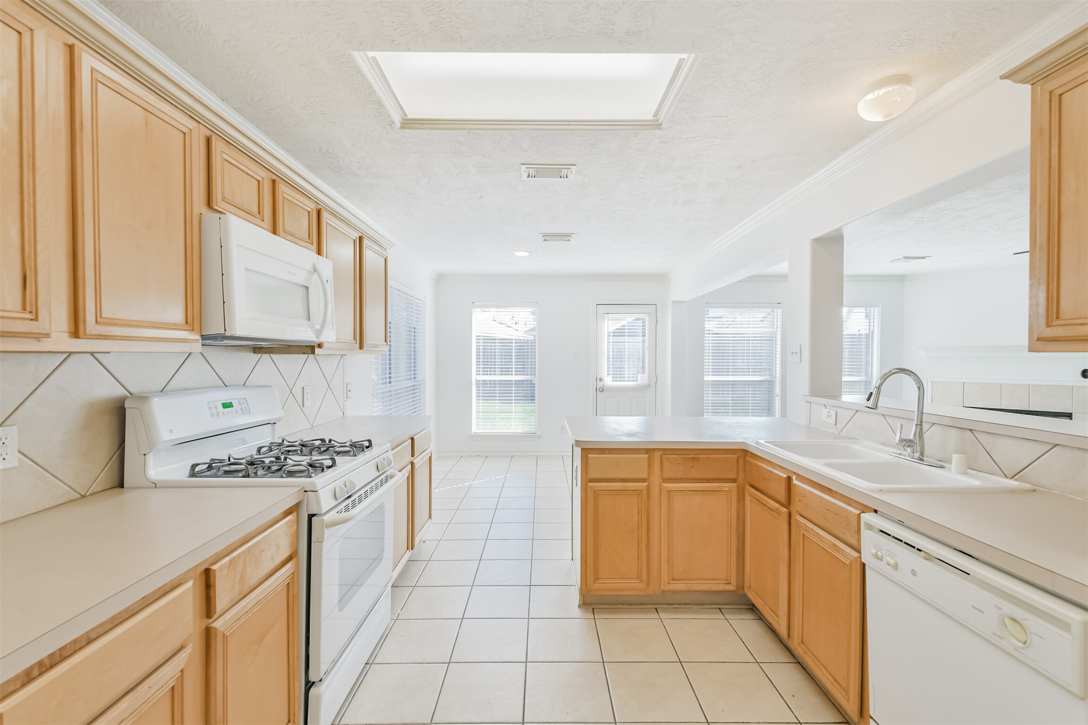 2507 Liza Court Spring, TX 77388 - Photo 13 of 37 a kitchen with stainless steel appliances a sink stove and cabinets