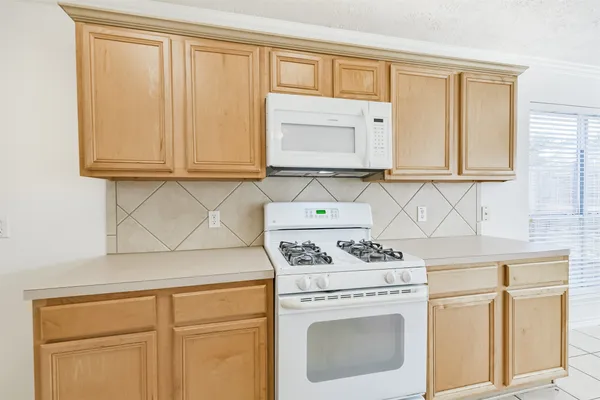 a kitchen with stainless steel appliances a sink stove and cabinets