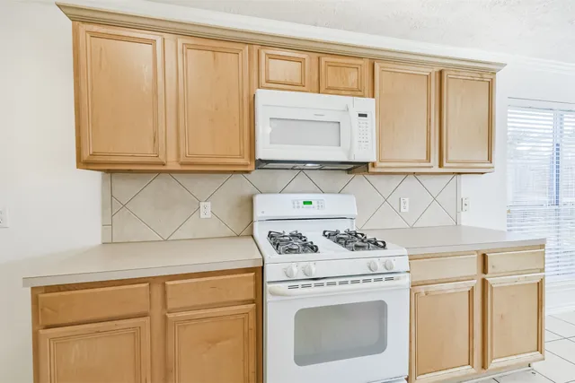 a kitchen with stainless steel appliances a sink stove and cabinets