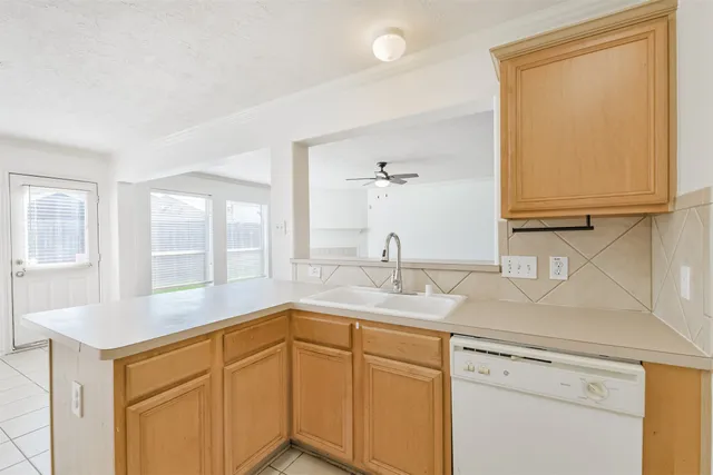 a kitchen with granite countertop cabinets stainless steel appliances and a counter space