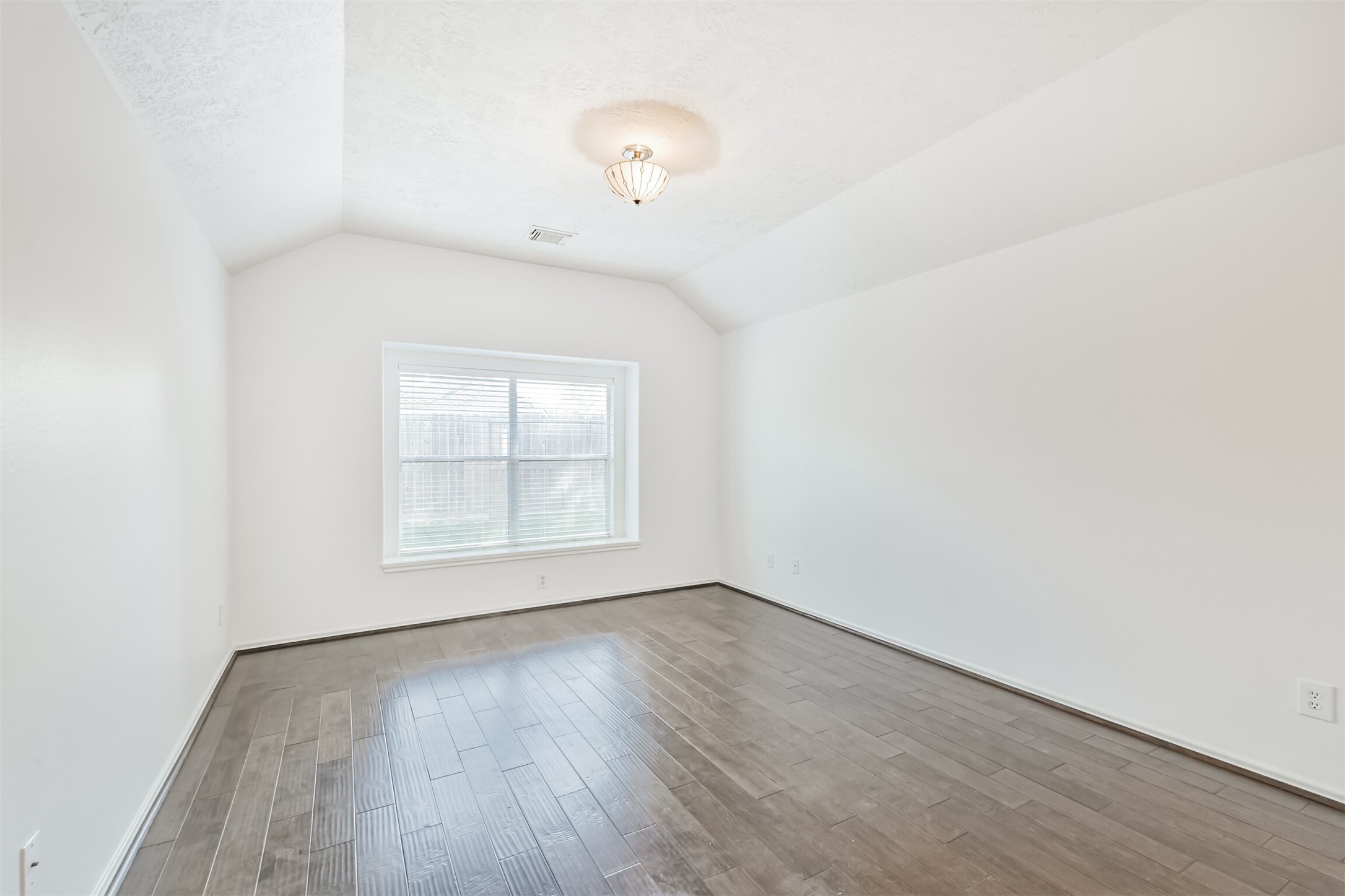 2507 Liza Court Spring, TX 77388 - Photo 18 of 37 an empty room with wooden floor and windows