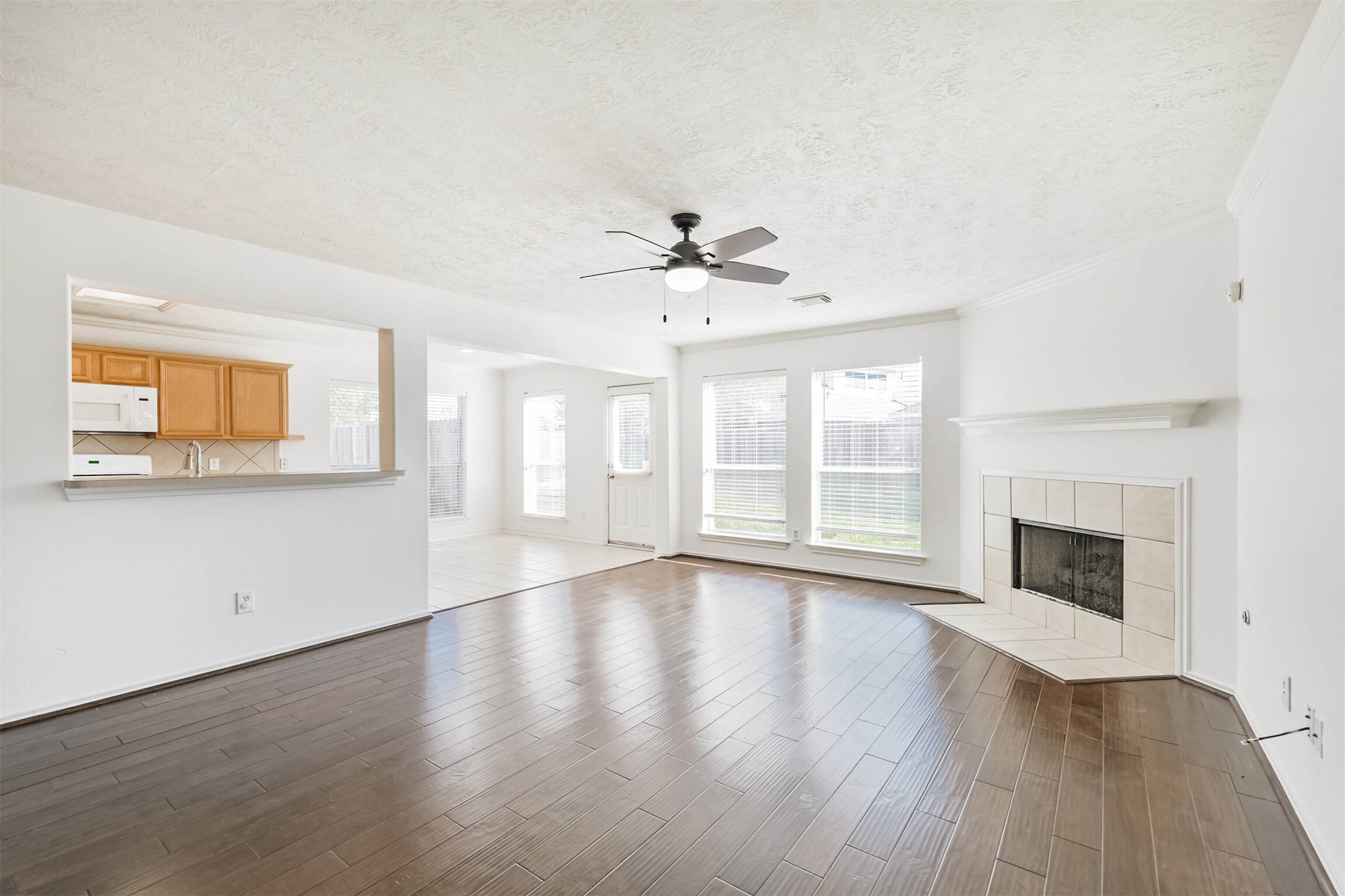 2507 Liza Court Spring, TX 77388 - Photo 35 of 37 an empty room with wooden floor fireplace and windows