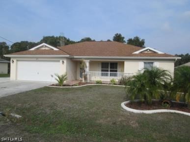 875 Rue Labeau Circle Fort Myers, FL 33913 - Photo 1 of 1 a front view of a house with a yard and garage