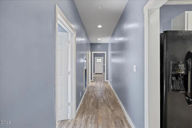 a view of hallway with wooden floor