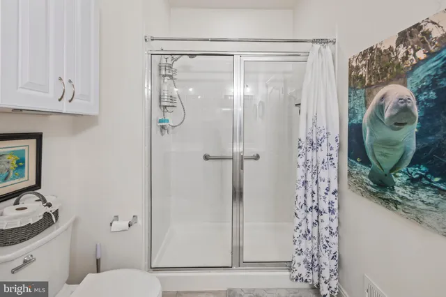 a view of walk in closet with clothes