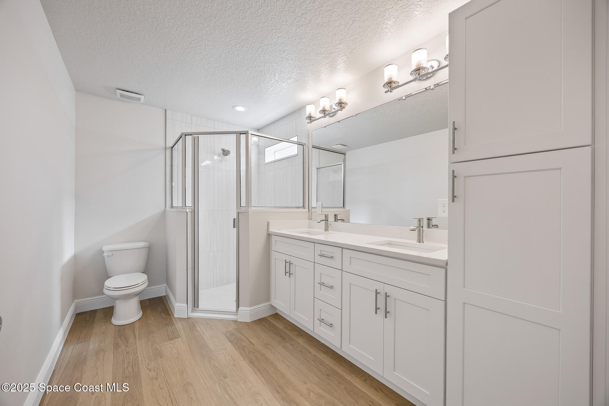 168 Hidden Wds Place Melbourne, FL 32901 - Photo 27 of 31 a spacious bathroom with a double vanity sink a toilet and a mirror
