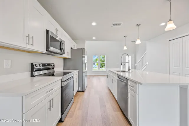 a large kitchen with stainless steel appliances lots of counter space sink and cabinets