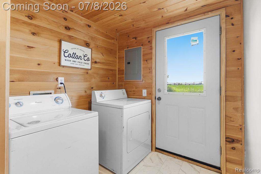 5698 McGrandy Road Bridgeport, MI 48722 - Photo 21 of 26 Utility room featuring wood-finish paneling on walls and ceiling, a white exterior door with a clear glass insert, and light-toned tile flooring