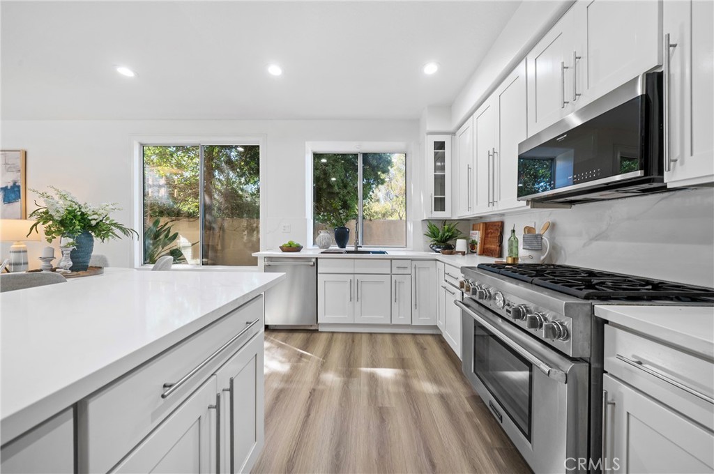 18 Broadleaf Irvine, CA 92612 - Photo 12 of 52 a kitchen with a stove a sink and a microwave