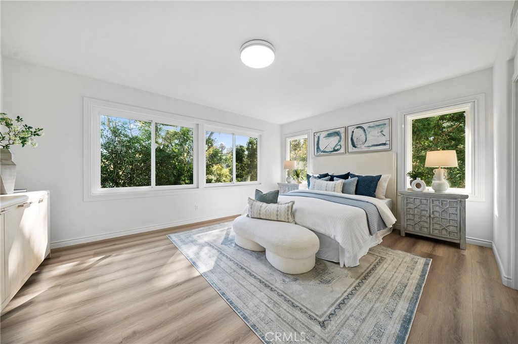 18 Broadleaf Irvine, CA 92612 - Photo 22 of 52 a bedroom with a bed and wooden floor