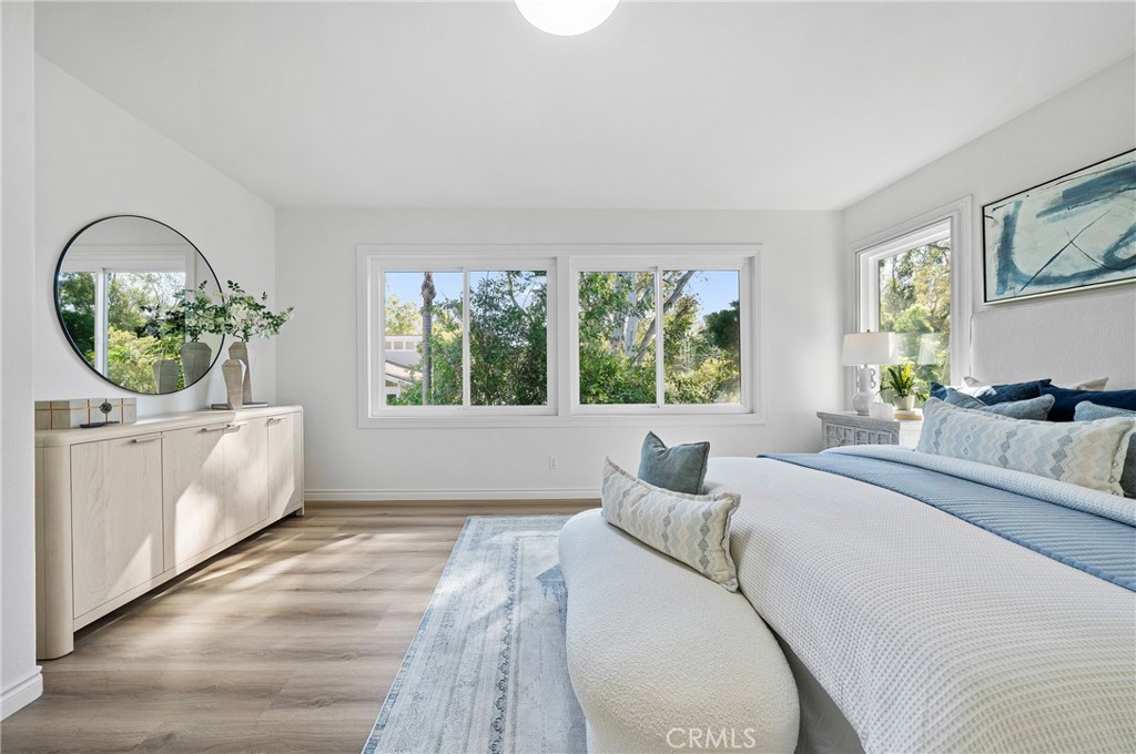 18 Broadleaf Irvine, CA 92612 - Photo 23 of 52 a bedroom with a large bed and a window