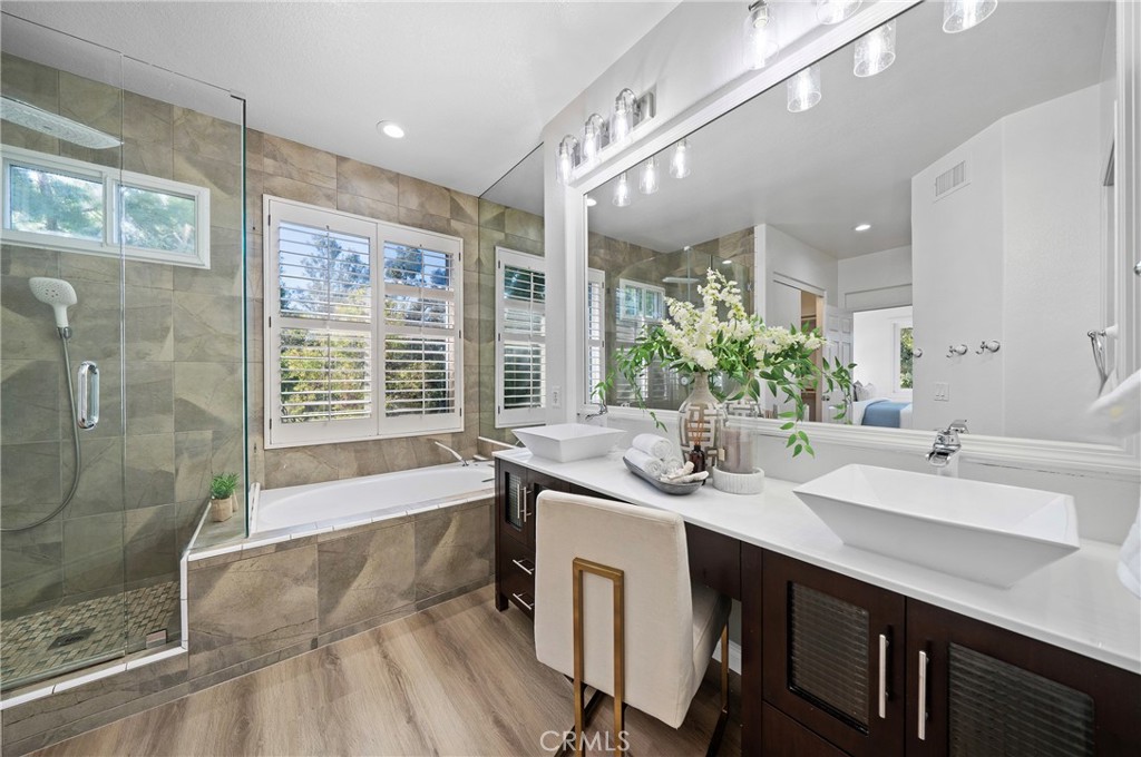 18 Broadleaf Irvine, CA 92612 - Photo 25 of 52 a spacious bathroom with a double vanity sink a large mirror and shower