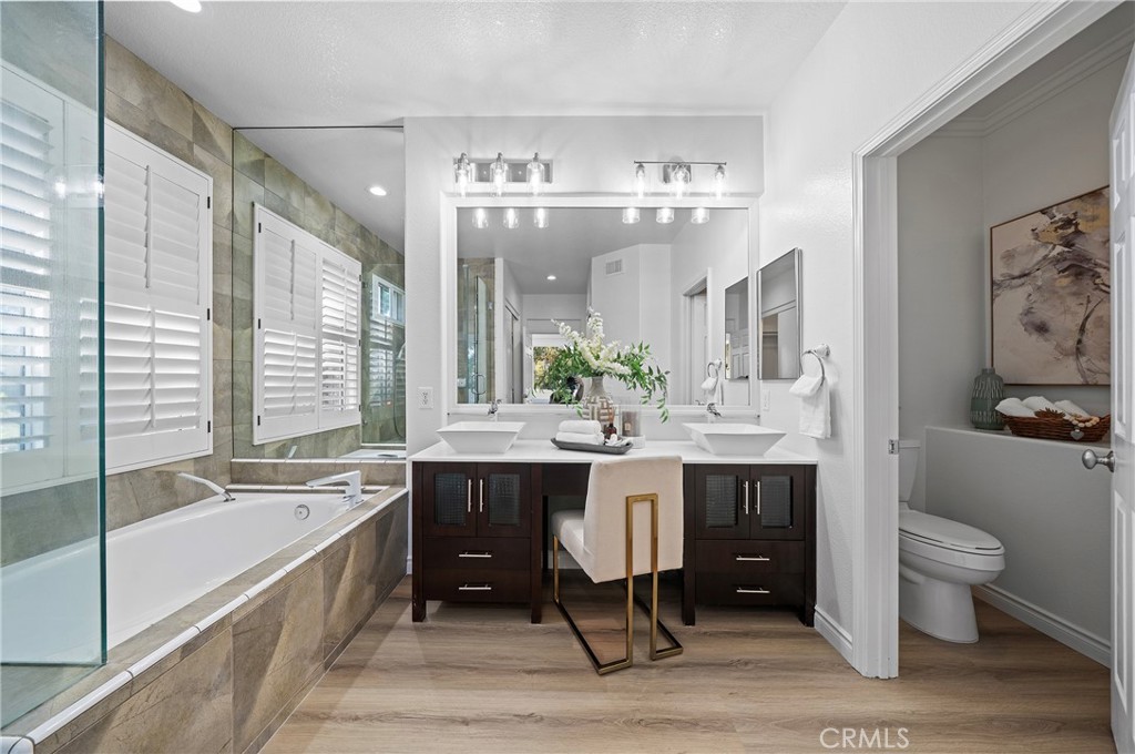 18 Broadleaf Irvine, CA 92612 - Photo 26 of 52 a spacious bathroom with a double vanity sink a large mirror and a bathtub