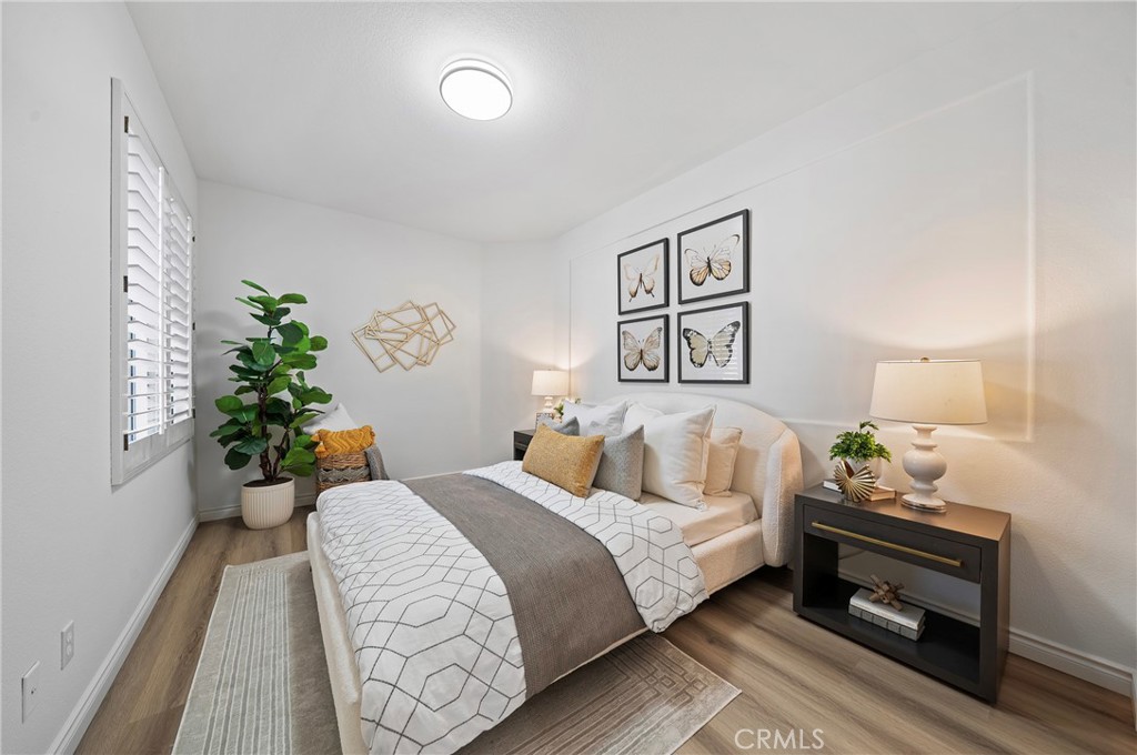 18 Broadleaf Irvine, CA 92612 - Photo 29 of 52 a bedroom with a bed and a potted plant