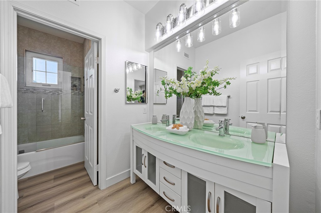 18 Broadleaf Irvine, CA 92612 - Photo 32 of 52 a bathroom with a granite countertop sink a mirror and a shower