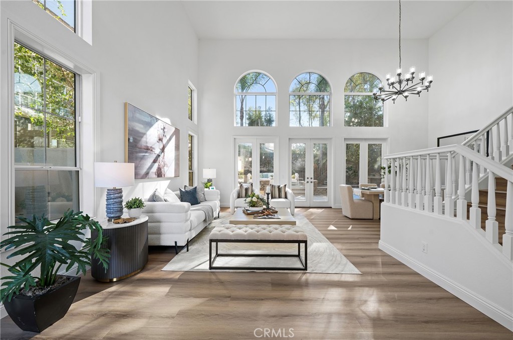 18 Broadleaf Irvine, CA 92612 - Photo 5 of 52 a living room with furniture chandelier and a large window