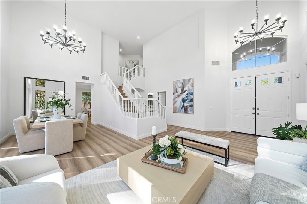 18 Broadleaf Irvine, CA 92612 - Photo 8 of 52 a living room with furniture and a chandelier