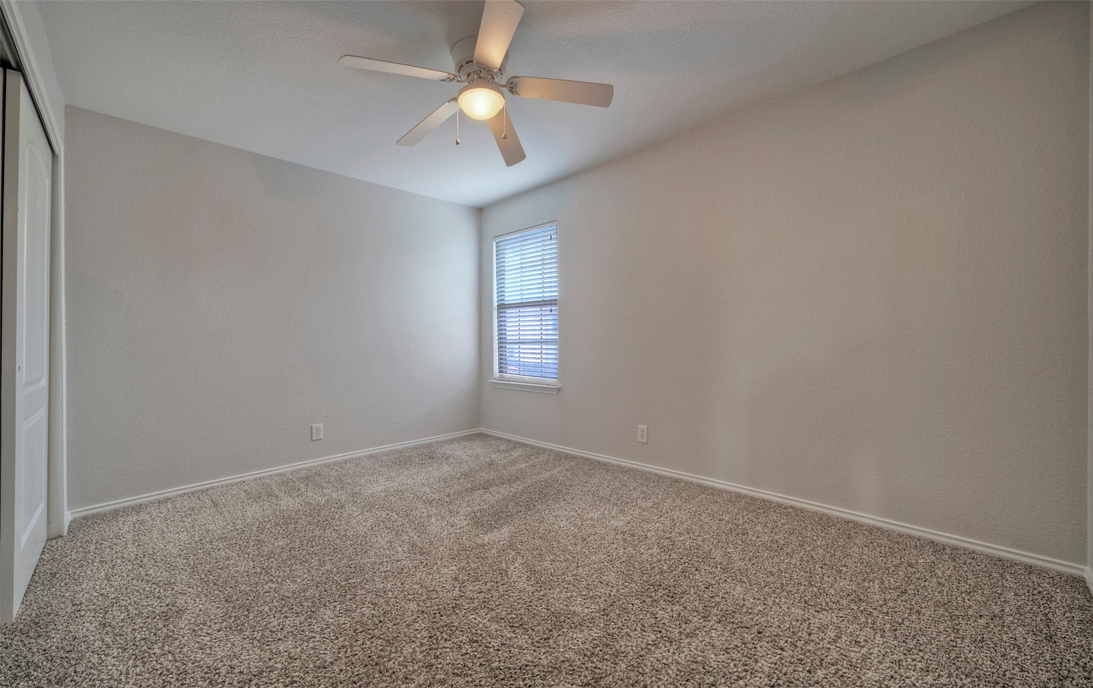 140 Plum Path Kyle, TX 78640 - Photo 12 of 22 an empty room with a window and a fan