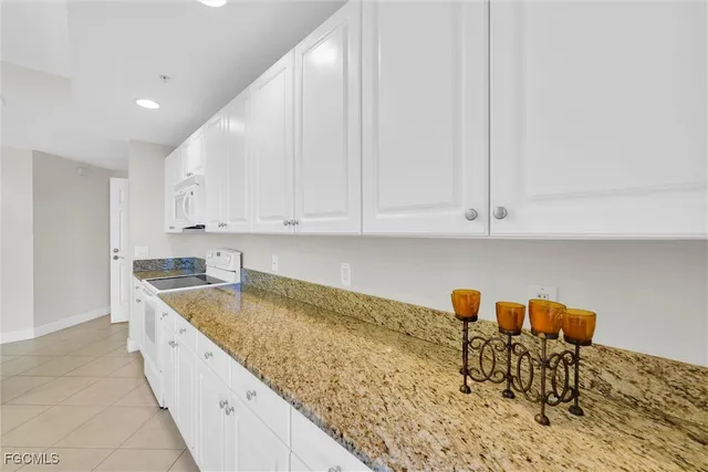 a bathroom with a granite countertop double sink and mirror