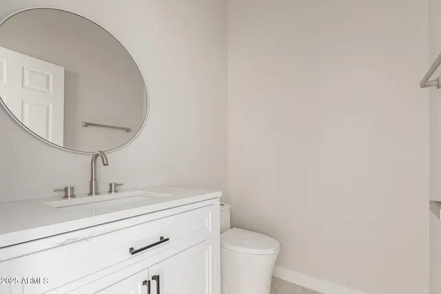 a kitchen with granite countertop white cabinets and a sink