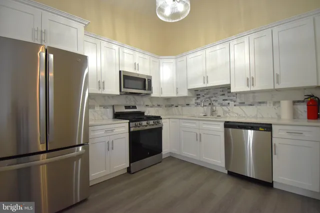 a kitchen with a refrigerator stove and microwave