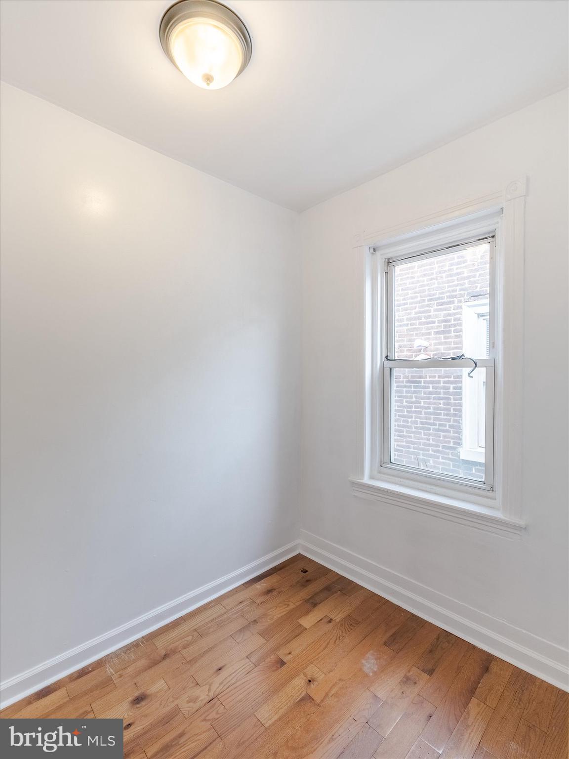131 South 50th Street Philadelphia, PA 19139 - Photo 23 of 27 an empty room with wooden floor and windows