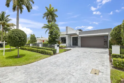 a view of a house with a swimming pool and a yard