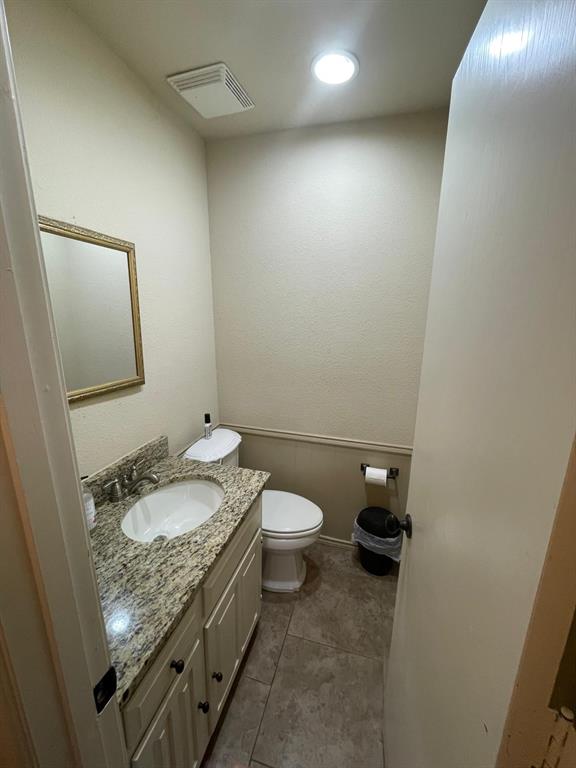 3612 Cross Bend Road Plano, TX 75023 - Photo 19 of 38 Bathroom featuring vanity, toilet, and tile floors