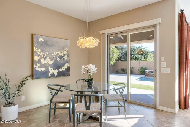 a view of a dining room with furniture a chandelier and wooden floor