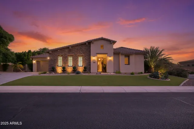 a front view of a house with a yard and road