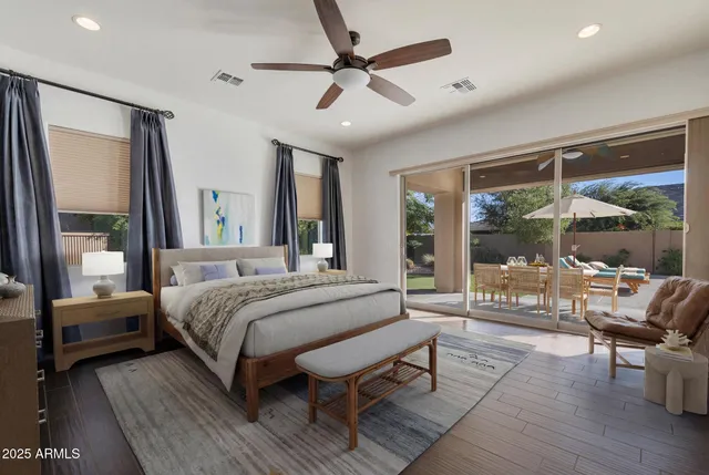 a bedroom with a large bed a flat screen tv and balcony