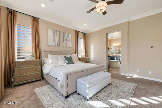 a spacious bedroom with a large bed a chandelier and closet