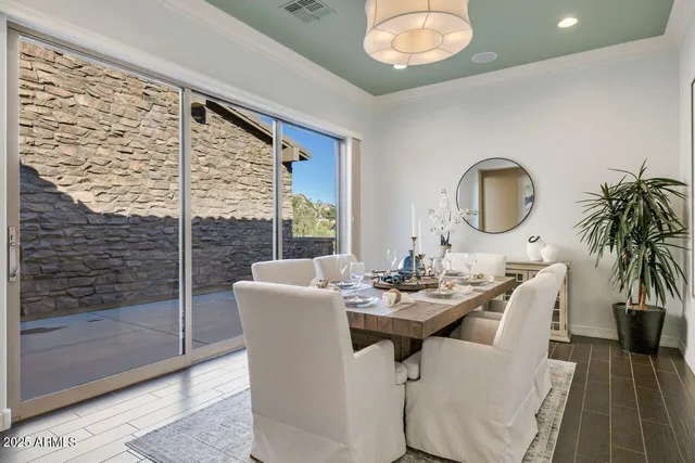 a dining room with furniture and a floor to ceiling window