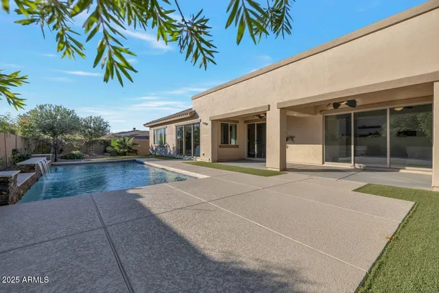 a view of a swimming pool with an outdoor seating and a garden
