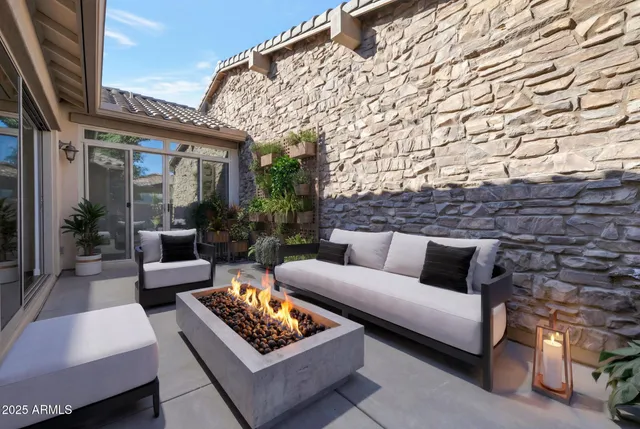 a outdoor living space with furniture and a fireplace