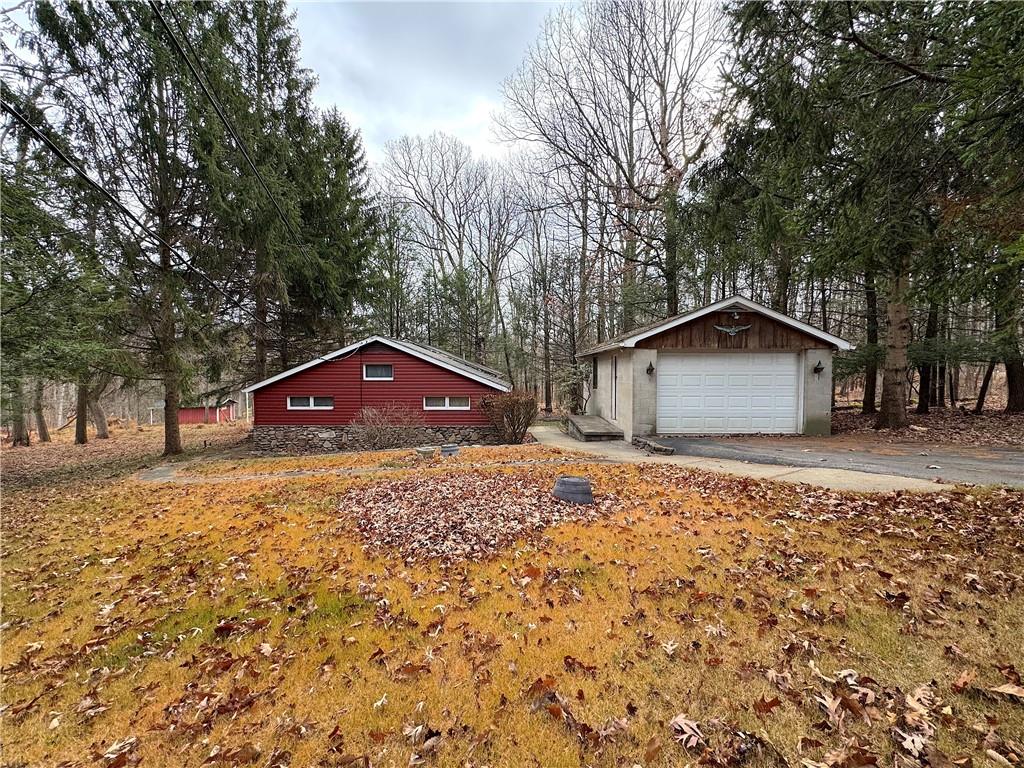 776 Highway 271 Ligonier, PA 15658 - Photo 2 of 29 a wooden house with a yard and large trees