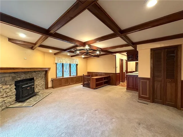 an empty room with furniture fireplace and windows