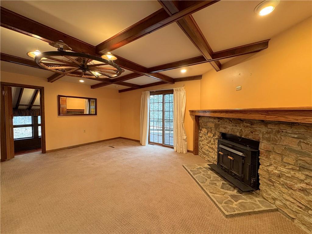 776 Highway 271 Ligonier, PA 15658 - Photo 5 of 29 a view of an empty room with a fireplace and a chandelier